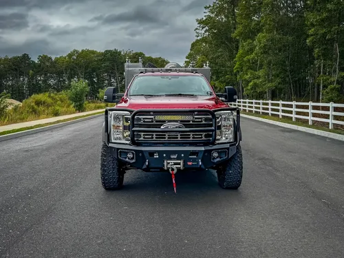 Head-on front exterior view showing grille guard, bumper, and front tire stance.